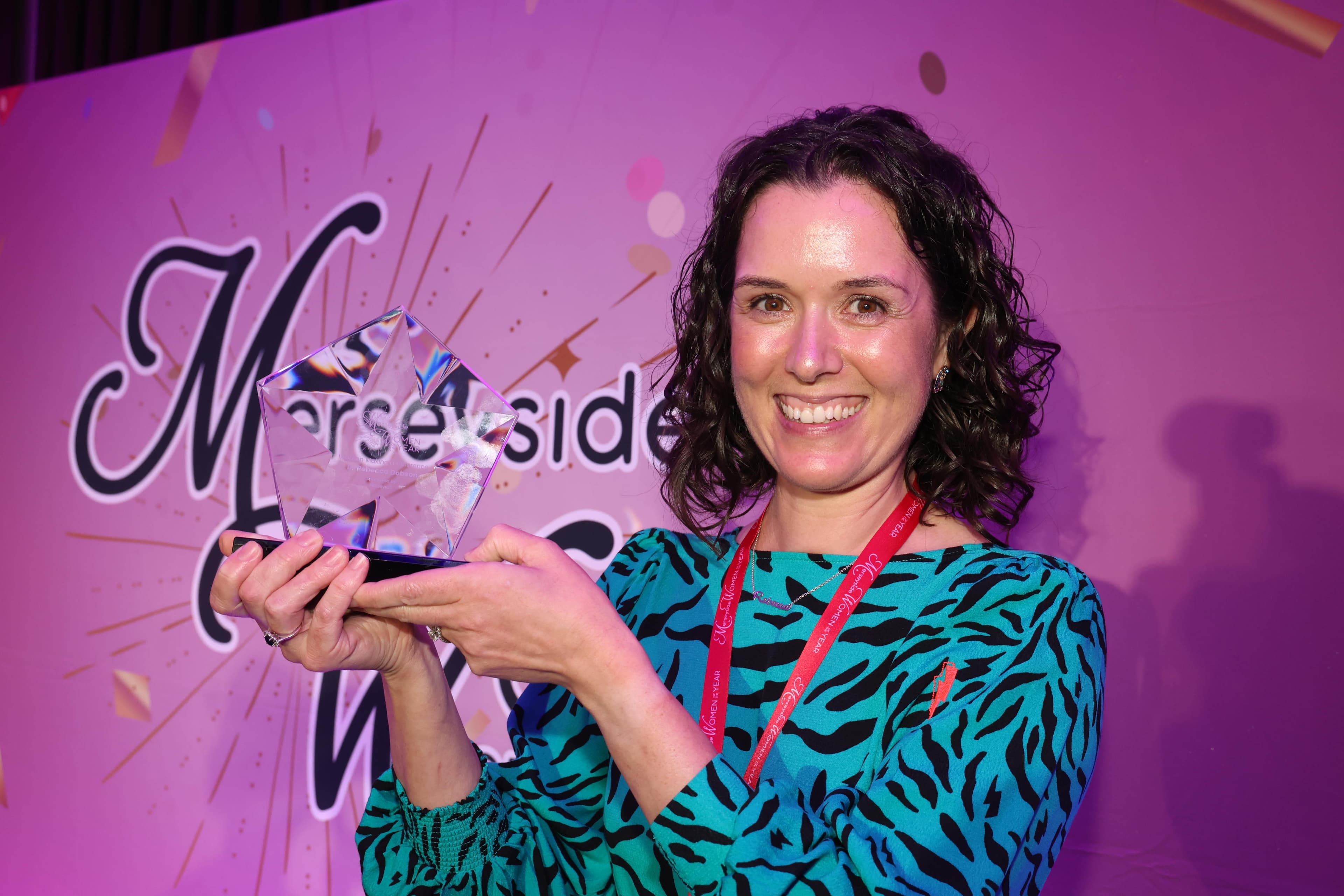 Dr Rebecca Dobson receiving Woman of the Year award for 2025